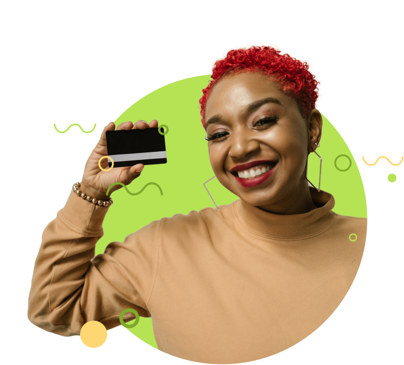 A woman holding up a credit card and smiling